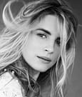 Black & white headshot of Brit Marling with hair blowing in wind